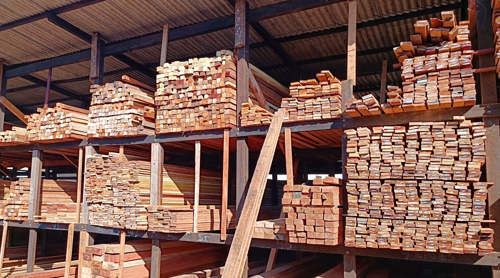 Stacked lumber boards in an industrial warehouse